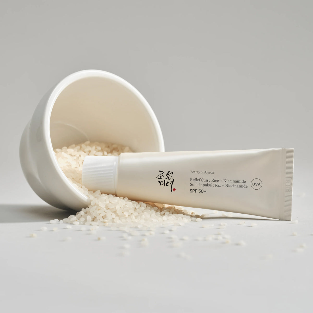 a white container with a tube of cream and rice