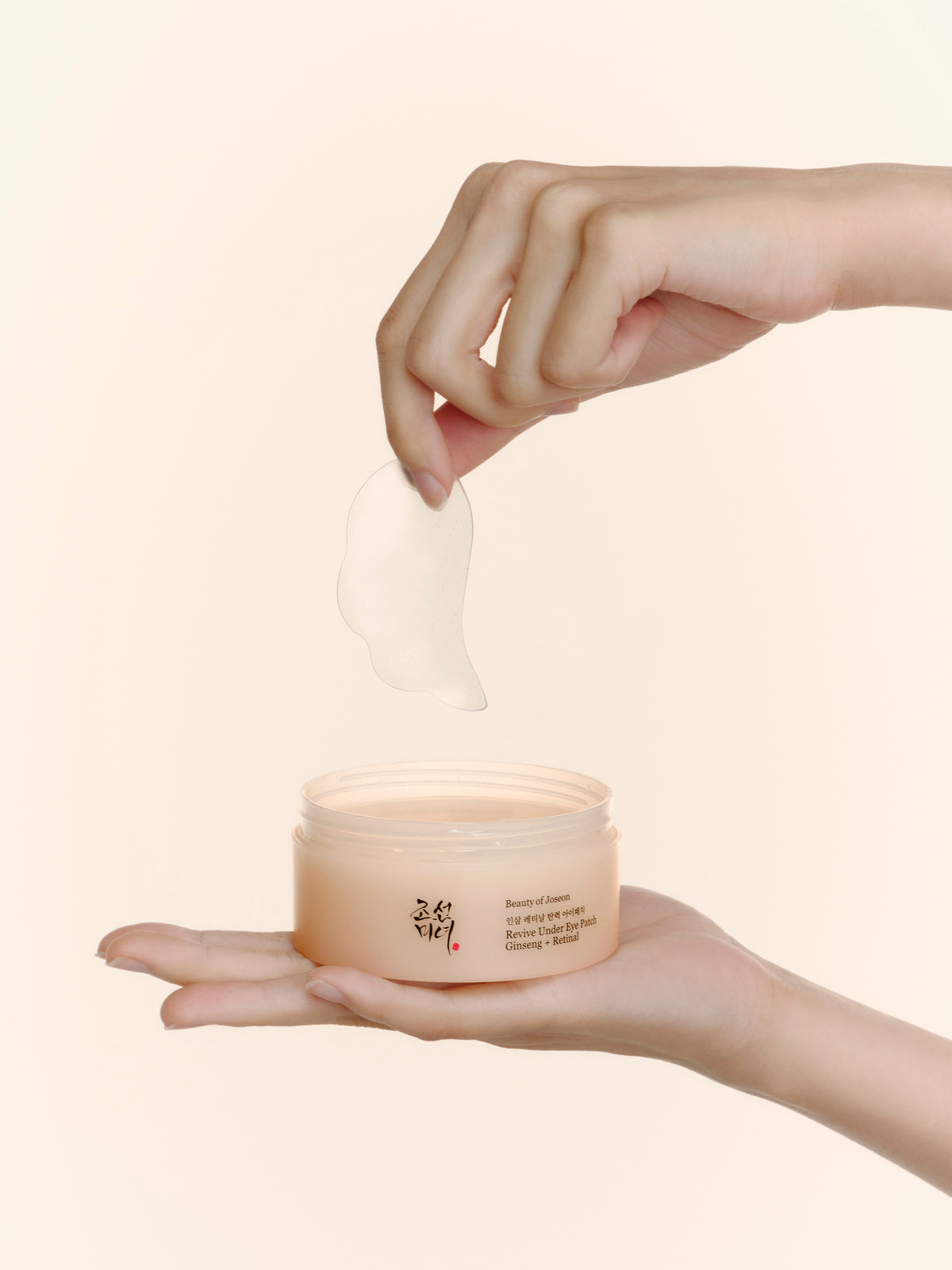 a person holding a container of cream