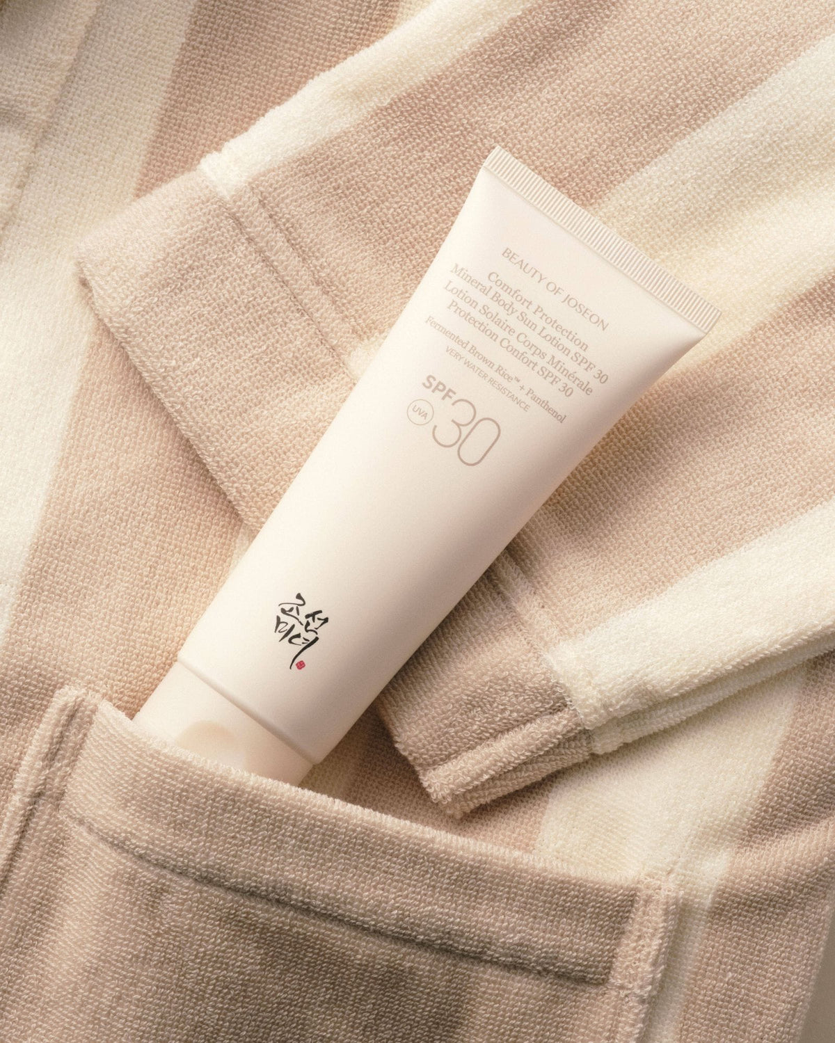 a cream tube in a pocket of a towel
